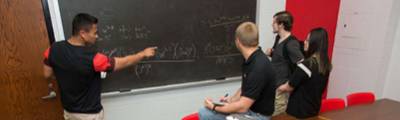 无码专区 students solving a math equation on a blackboard