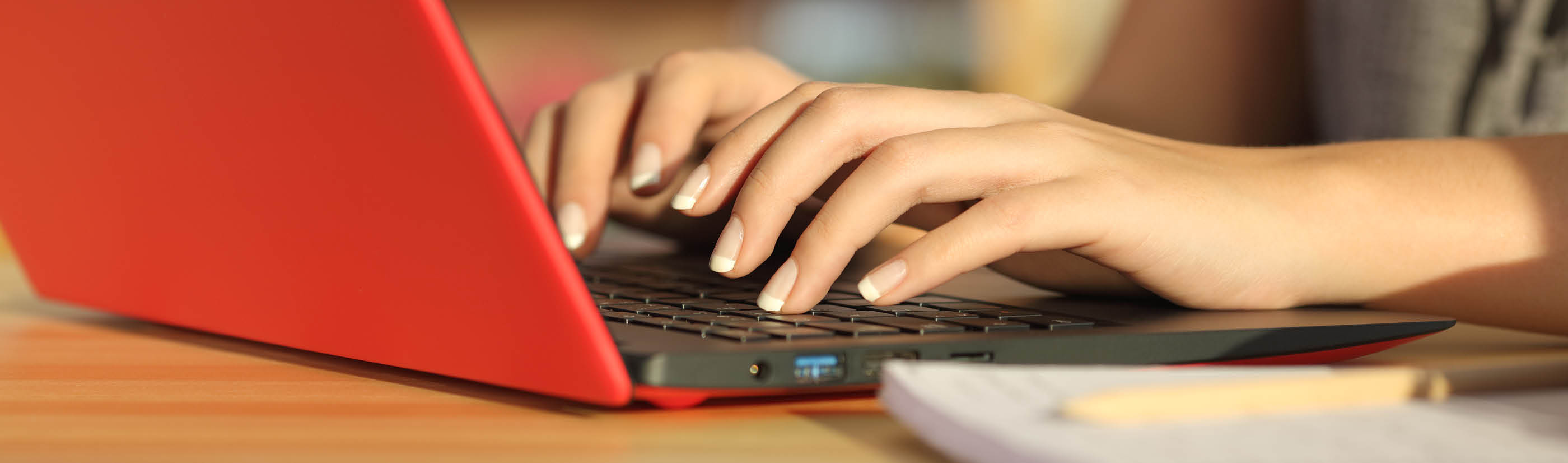 A person using a red laptop